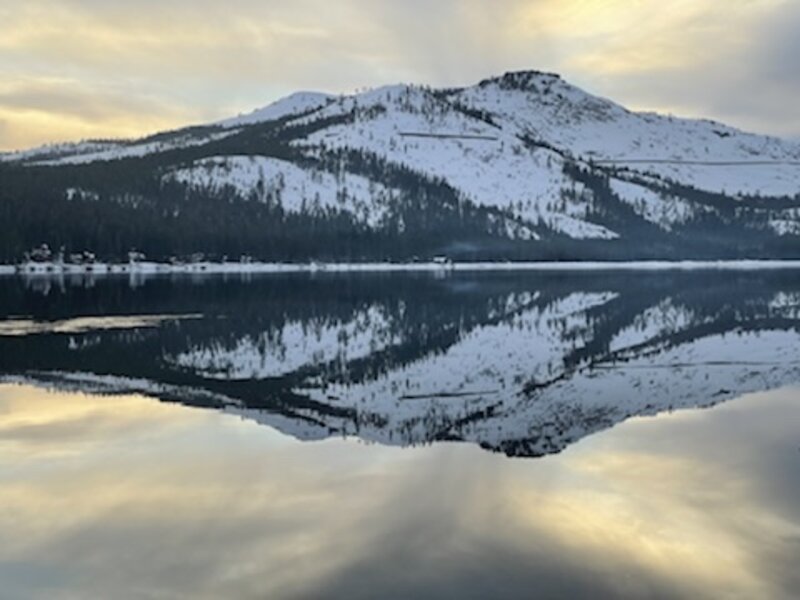 Winter mountain reflection on still water